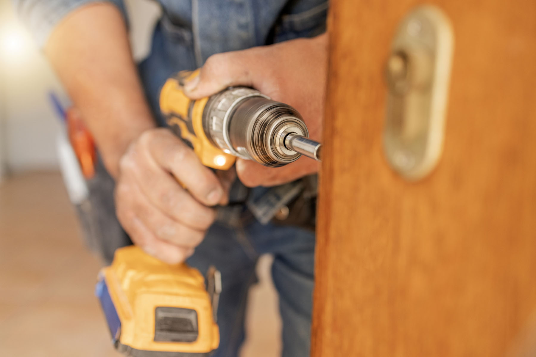 Locksmith, maintenance and handyman with drill, home renovation and fixing, change door locks with .